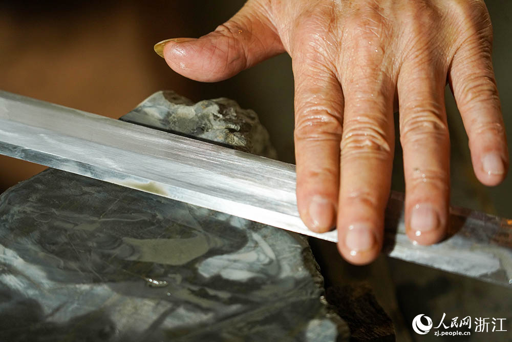 在浙江省龍泉市沈廣隆劍鋪，沈新培正在精磨寶劍劍坯。人民網(wǎng) 章勇濤攝